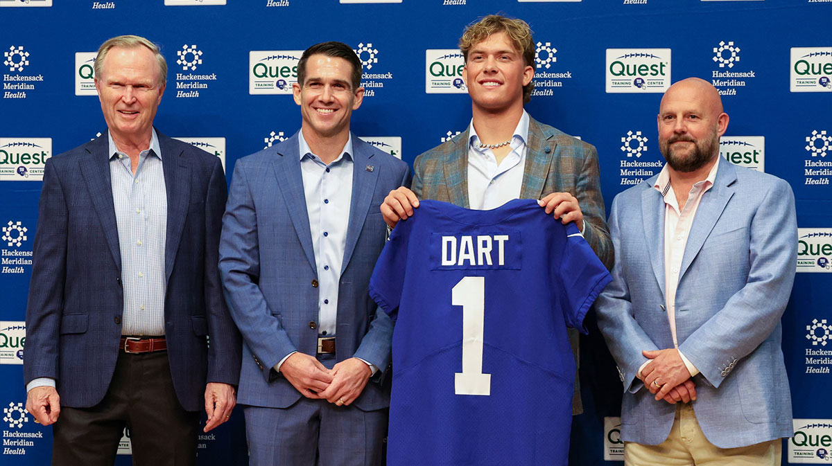 New York Giants president John Mara (far left), general manager Joe Schoen (left), Jaxson Dart, and head coach Brian Daboll (right) pose for photos prior to the start of the press conference to introduce the Giants first round draft picks.