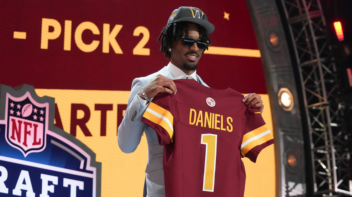 LSU Tigers quarterback Jayden Daniels poses after being selected by the Washington Commanders as the No. 2 pick in the first round of the 2024 NFL Draft at Campus Martius Park and Hart Plaza.
