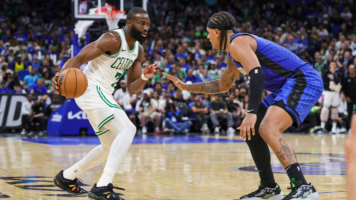 The goalkeeper of Boston Celtics Jaylen Brown (7) manages the ball in front of the Magic Orlando striker, Paolo Banchero (5) during the second half of the third round match for the NBA 2025 qualifiers at the Kia Center.