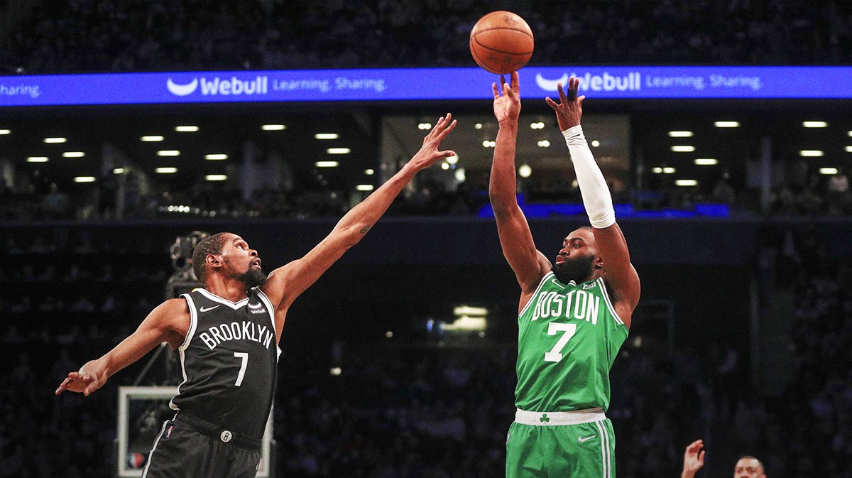 Boston Celtics guard Jaylen Brown (7) takes a three point shot over Brooklyn Nets forward Kevin Durant (7) in the first quarter at Barclays Center.