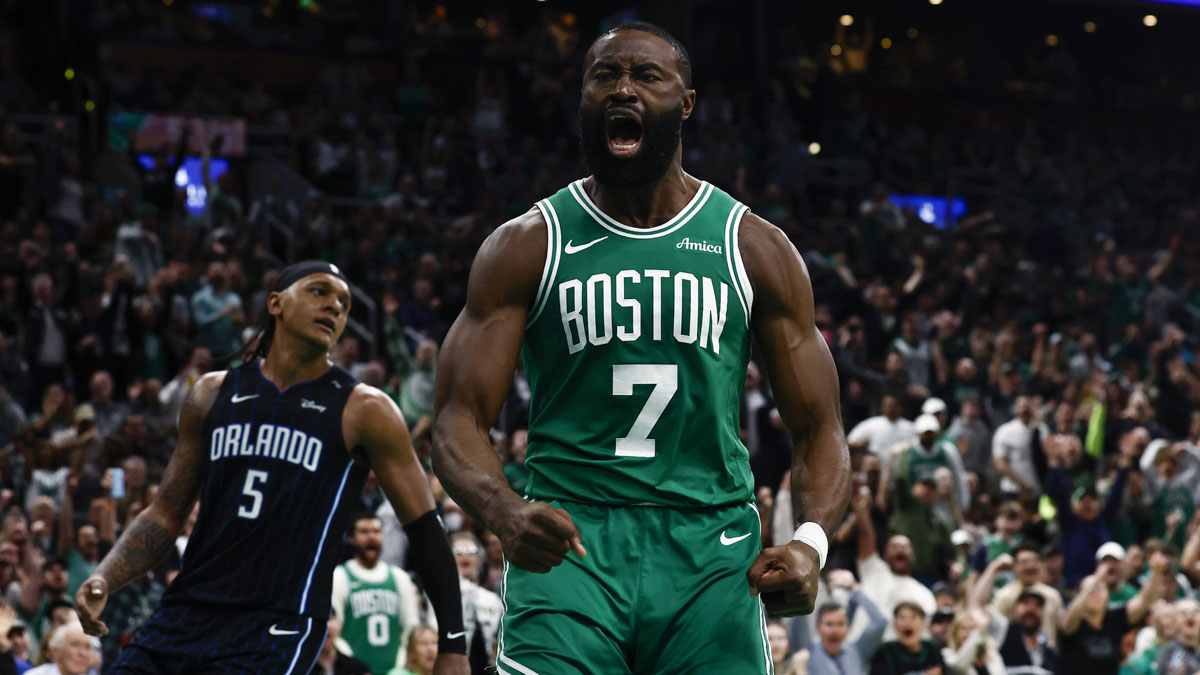 Boston Celtics guard Jaylen Brown (7) shouts out after dunking as Orlando Magic forward Paolo Banchero (5) turns away during the second half of game two of the first round of the 2024 NBA Playoffs at TD Garden.