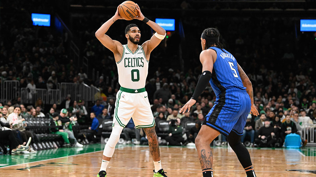 Boston Celtics forward Jayson Tatum (0) looks to pass the ball over Orlando Magic forward Paolo Banchero (5) during the second half at TD Garden. 