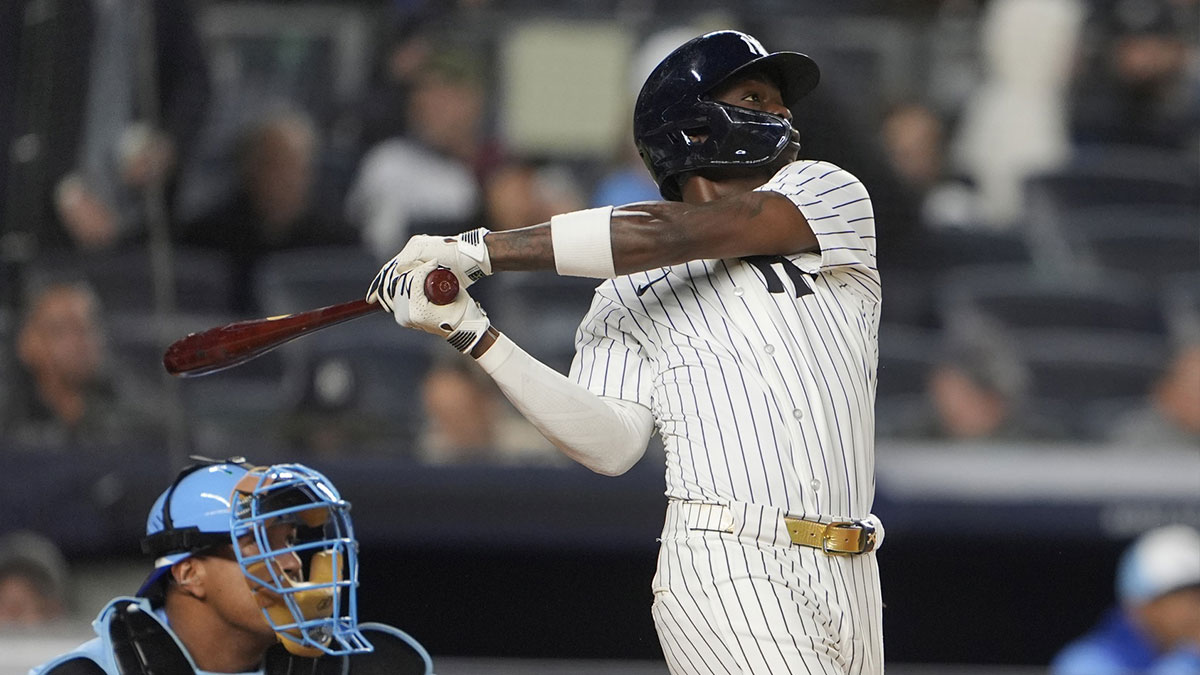 New York Yankees second baseman Jazz Chisholm Jr. (13) hits a home run against the Kansas City Royals during the fourth inning at Yankee Stadium.