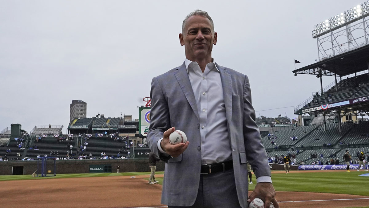 Jed Hoyer President of the Chicago Cubs prepares to throw balls to fans before a game against the San Diego Padres at Wrigley Field