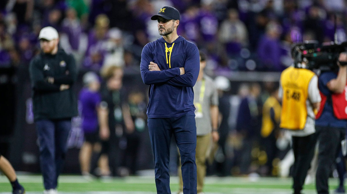 Michigan defensive coordinator Jesse Minter watches warm ups before the national championship game at NRG Stadium