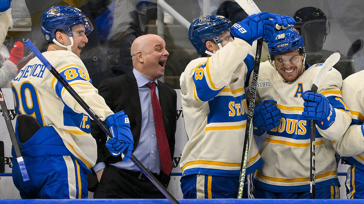 St. Louis Blues left wing Pavel Buchnevich (89) head coach Jim Montgomery center Dylan Holloway (81) and center Robert Thomas (18) react after center Radek Faksa (not pictured) scored the game winning goal in the 10th round of shootouts against the Chicago Blackhawks at Enterprise Center.