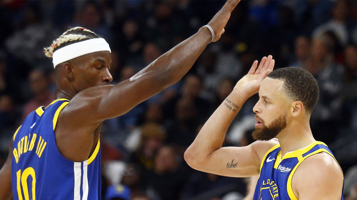 Golden State Warriors forward Jimmy Butler III (10) reacts with guard Stephen Curry (30) during the fourth quarter against the Memphis Grizzlies at FedExForum.
