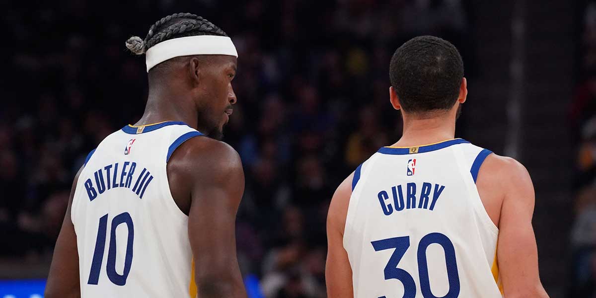 Golden State Warriors forward Jimmy Butler III (10) talks with guard Stephen Curry (30) during a game against the Detroit Pistons in the second quarter at Chase Center.