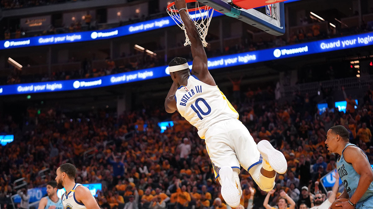 Golden State Warriors forward Jimmy Butler III (10) hangs on the rim after dunking the ball against the Memphis Grizzlies in the third quarter at the Chase Center.