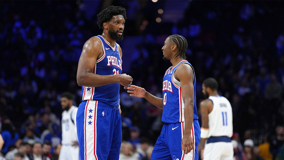 Philadelphia 76ers center Joel Embiid (21) reacts with guard Tyrese Maxey (0) against the Dallas Mavericks in the second quarter at Wells Fargo Center