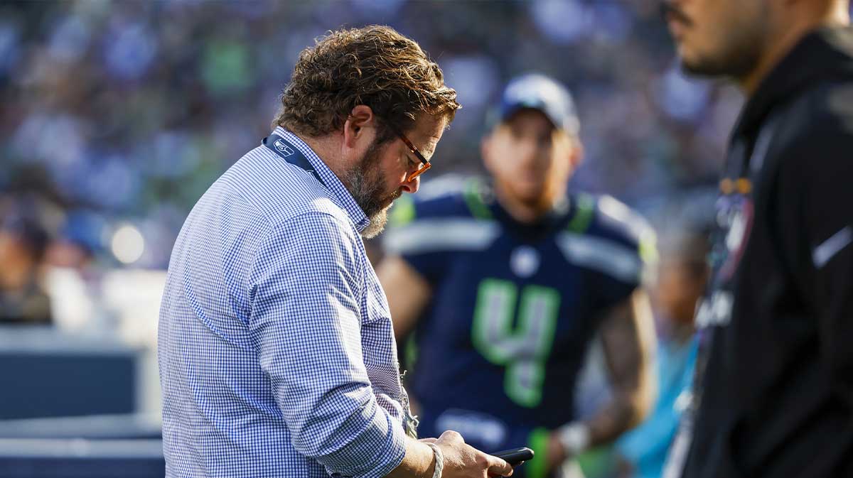 Seattle Seahawks general manager John Schneider looks at his phone during the fourth quarter against the New York Giants at Lumen Field. Mandatory Credit: Joe Nicholson-Imagn Images