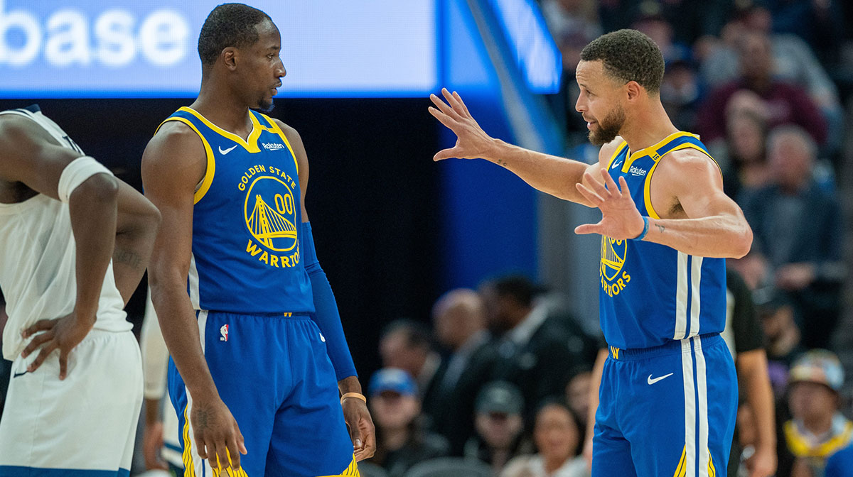 Golden State Warriors guard Stephen Curry (30) speaks with forward Jonathan Kuminga (00) during a time out against the Minnesota Timberwolves during the fourth quarter at Chase Center.