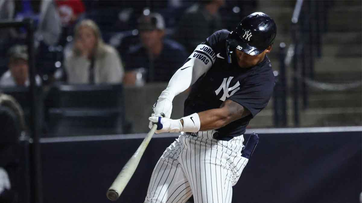 Mar 7, 2025; Tampa, Florida, USA; New York Yankees second base Jorbit Vivas (90) hits a single during the second inning against the Toronto Blue Jays at George M. Steinbrenner Field.