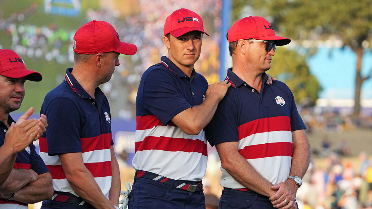 Team USA golfers Jordan Spieth and Justin Thomas reacts with captain Zach Johnson after Team Europe beat Team USA during the final day of the 44th Ryder Cup golf competition at Marco Simone Golf and Country Club