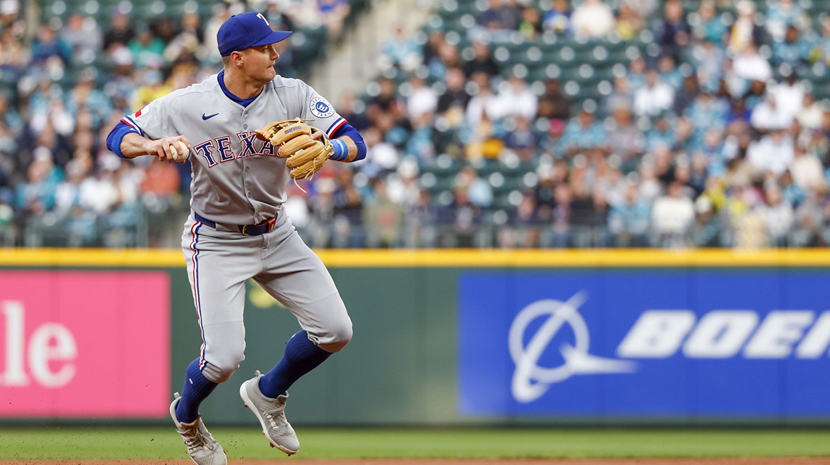 Texas Rangers third baseman Josh Jung (6) throws to first base after fielding a ground ball against the Seattle Mariners during the first inning at T-Mobile Park