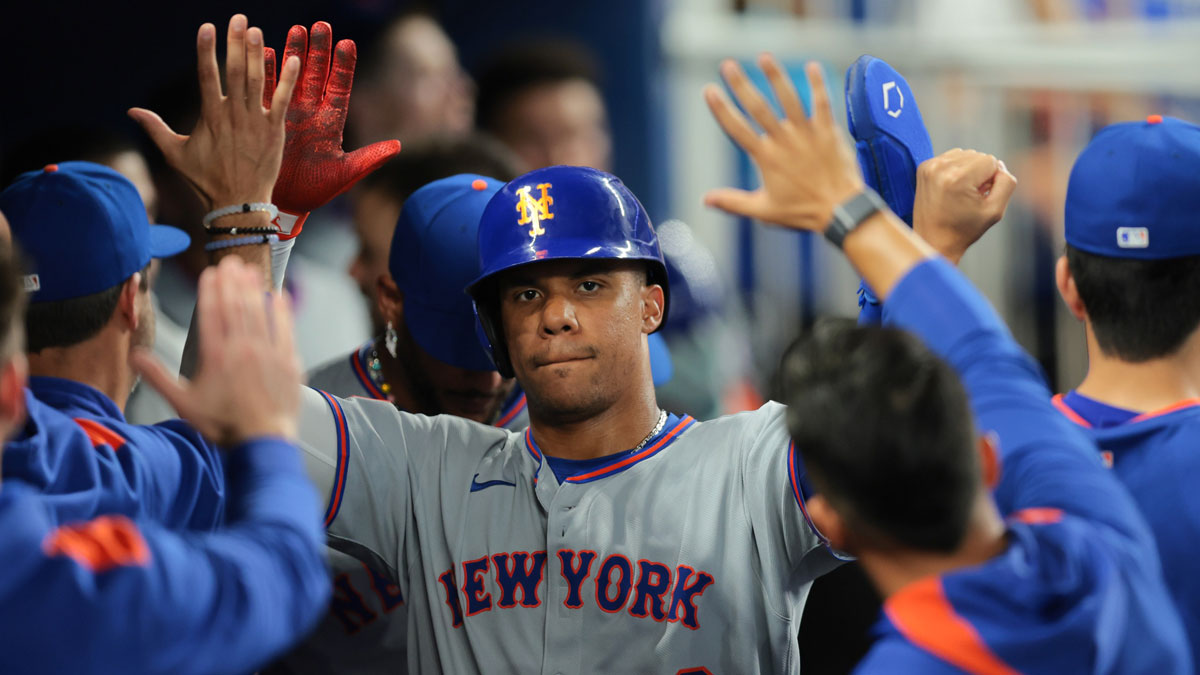 New York Mets right fielder Juan Soto (22) celebrates with teammates after scoring against the Miami Marlins during the eleventh inning at loanDepot Park.