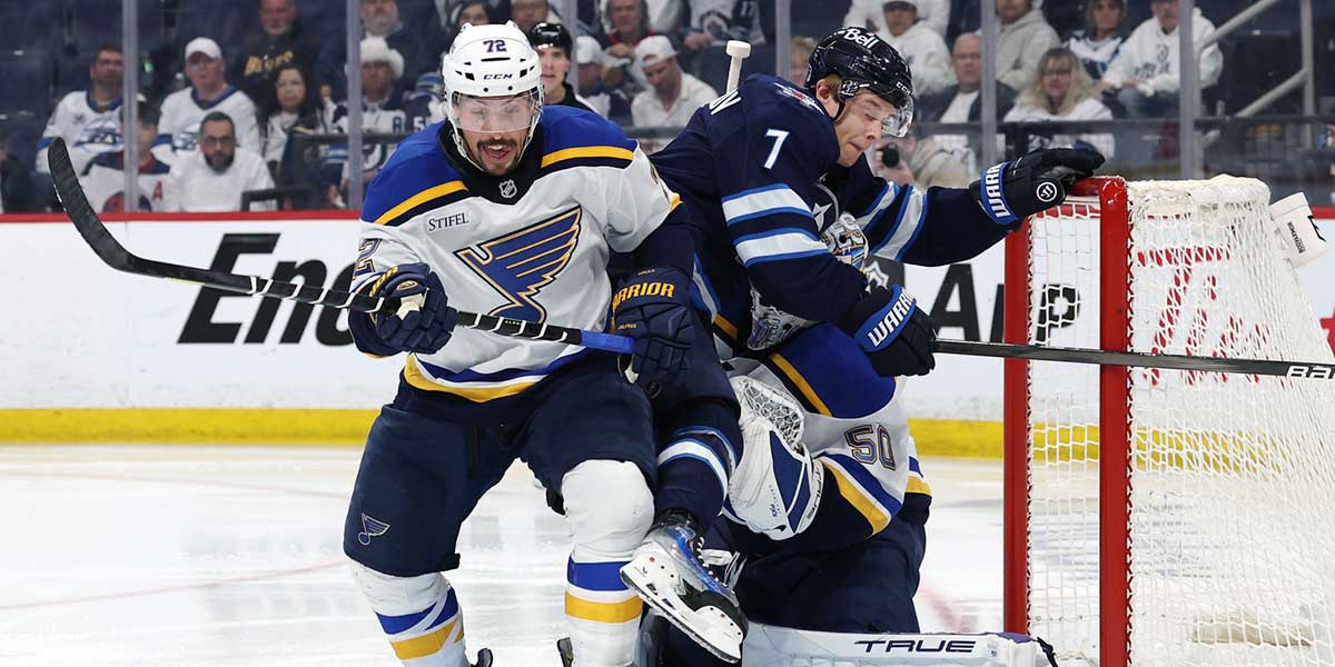 St. Louis Blues defenseman Justin Faulk (72) chases a rebound as Winnipeg Jets center Vladislav Namestnikov (7) and St. Louis Blues goaltender Jordan Binnington (50) are tangled up in the second period in game two of the first round of the 2025 Stanley Cup Playoffs at Canada Life Centre.