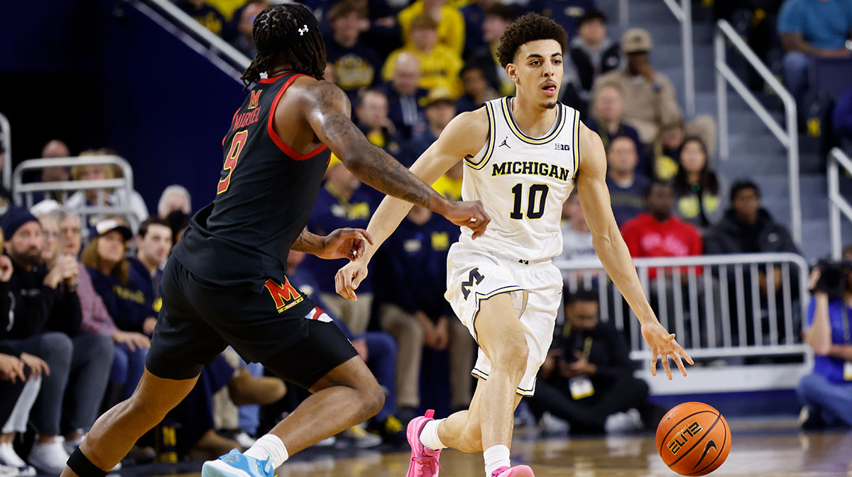 Michigan Wolverines guard Justin Pippen (10) dribbles defended by Maryland Terrapins guard Selton Miguel (9) in the first half at Crisler Center.