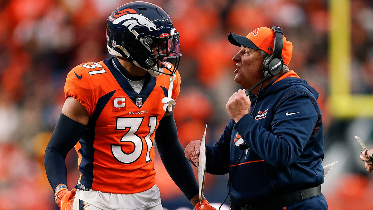 Denver Broncos head coach Vic Fangio talks with safety Justin Simmons (31) in the fourth quarter against the Washington Football Team at Empower Field at Mile High.