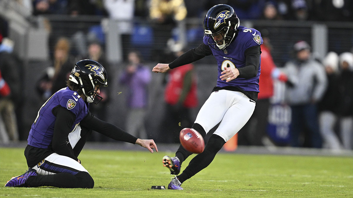 Baltimore Ravens place kicker Justin Tucker (9) kicks off as punter Jordan Stout (11) holds during the first quarter against the Cleveland Browns at M&T Bank Stadium.
