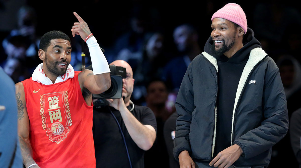 Former Brooklyn Nets guard and now Mavericks player Kyrie Irving (11) and now Suns forward Kevin Durant (7) react after being announced as 2013 all stars during the second quarter against the Detroit Pistons at Barclays Center.