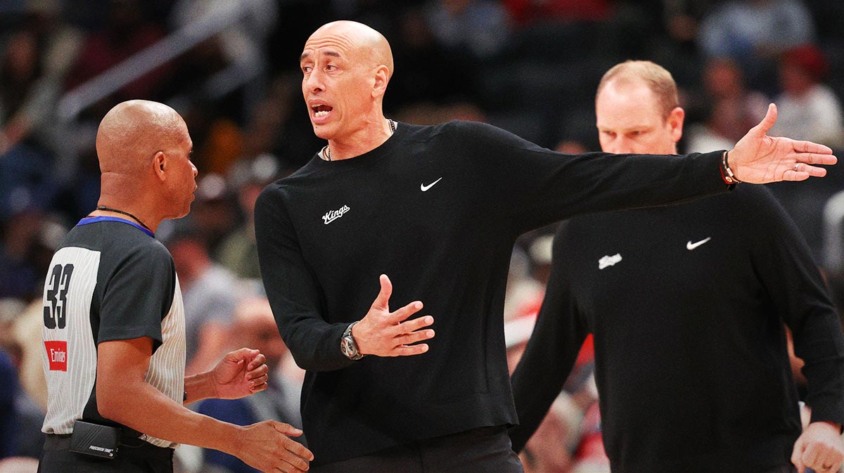 Sacramento Kings head coach Doug Christie (R) argues with referee Sean Corbin (33) against the Washington Wizards in the second half at Capital One Arena.