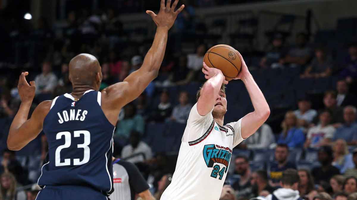 Memphis Grizzlies guard Cam Spencer (24) shoots for three as Dallas Mavericks forward Kai Jones (23) defends during the fourth quarter at FedExForum.