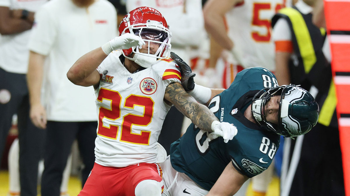 Kansas City Chiefs cornerback Trent McDuffie (22) and Philadelphia Eagles tight end Dallas Goedert (88) battle for position as they look for the ball in the first quarter in Super Bowl LIX at Ceasars Superdome.