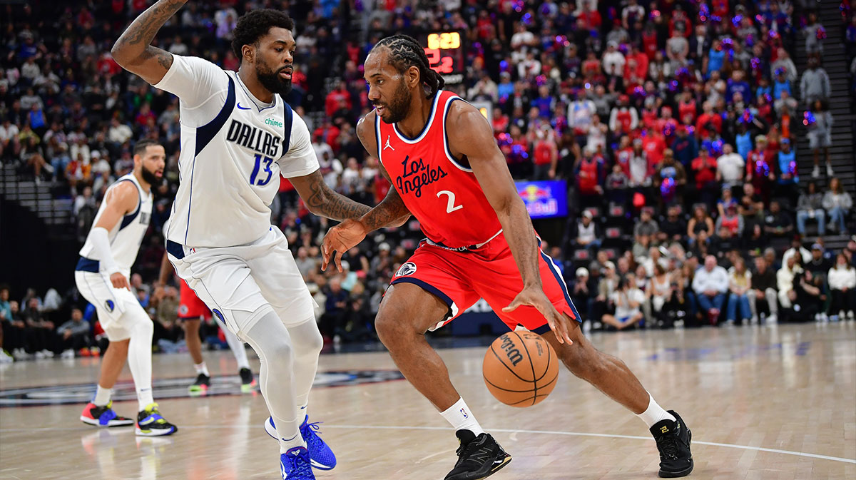 Los Angeles Clippers forward Kawhi Leonard (2) moves the ball against Dallas Mavericks forward Naji Marshall (13) during the first half at Intuit Dome.