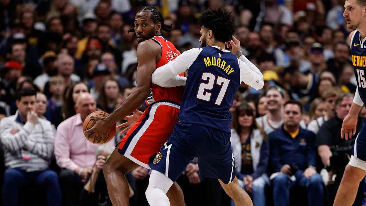 Los Angeles Clippers forward Kawhi Leonard (2) controls the ball as Denver Nuggets guard Jamal Murray (27) guards and center Nikola Jokic (15) defends in the third quarter during game two of first round for the 2025 NBA Playoffs at Ball Arena. Mandatory Credit: Isaiah J. Downing-Imagn Images