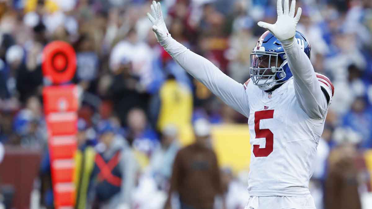 Nov 19, 2023; Landover, Maryland, USA; New York Giants linebacker Kayvon Thibodeaux (5) celebrates after making a sack against the Washington Commanders during the fourth quarter at FedExField. Mandatory Credit: Geoff Burke-Imagn Images