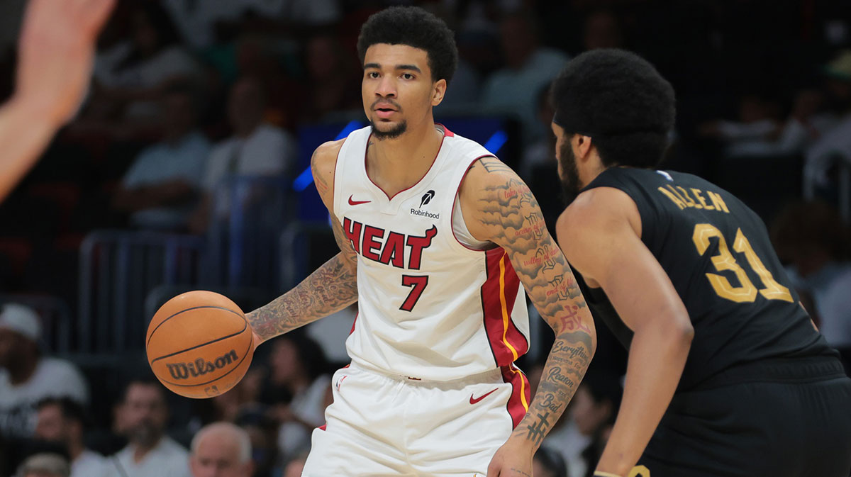 Miami Heat center Kel'el Ware (7) dribbles the basketball as Cleveland Cavaliers center Jarrett Allen (31) defends in the third quarter during game three for the first round of the 2025 NBA Playoffs at Kaseya Center.