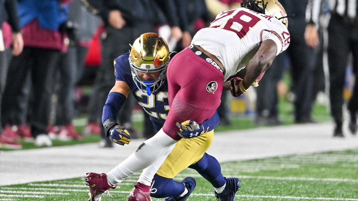 Notre Dame Fighting Irish safety Kennedy Urlacher (23) tackles Florida State Seminoles linebacker Justin Cryer (28) in the fourth quarter at Notre Dame Stadium.