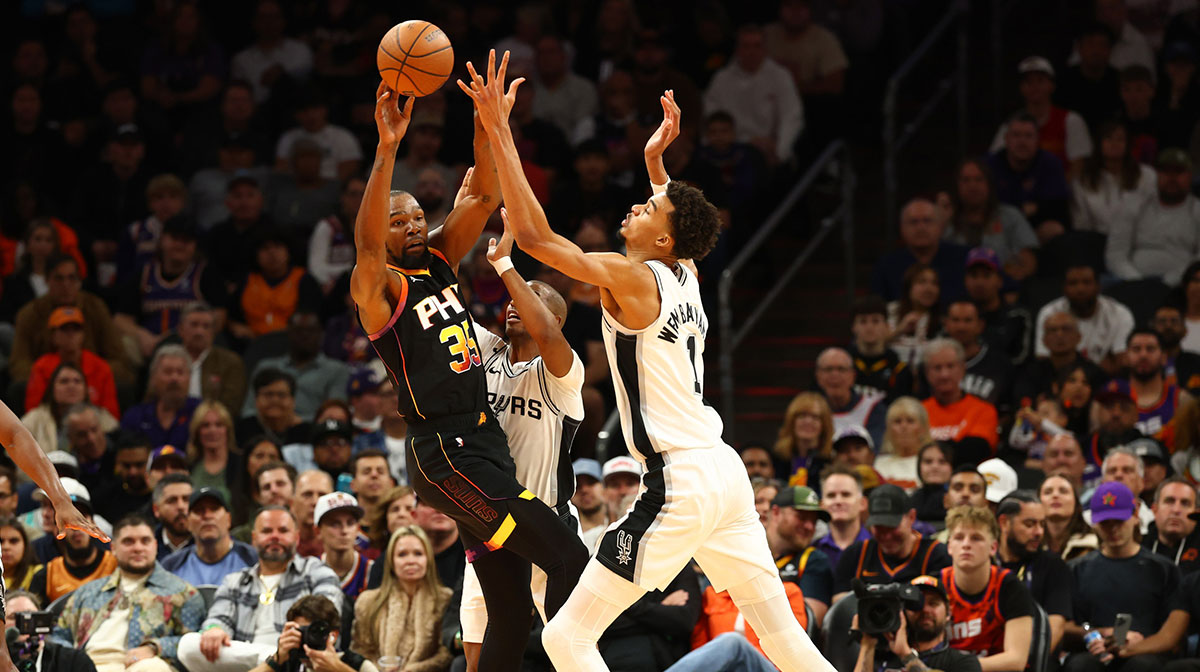 Phoenix Suns forward Kevin Durant (35) against San Antonio Spurs center Victor Wembanyama (1) in the first half of an NBA Cup game at Footprint Center.