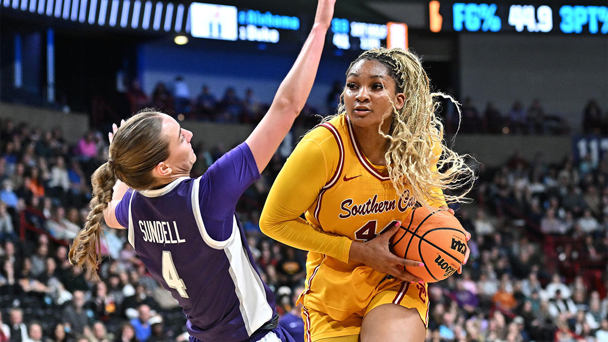 Kansas State Wildcats guard Serena Sundell (4) takes a charge from USC Trojans forward Kiki Iriafen (44) during the second half of a Sweet 16 NCAA Tournament basketball game against the Kansas State Wildcats at Spokane Arena.