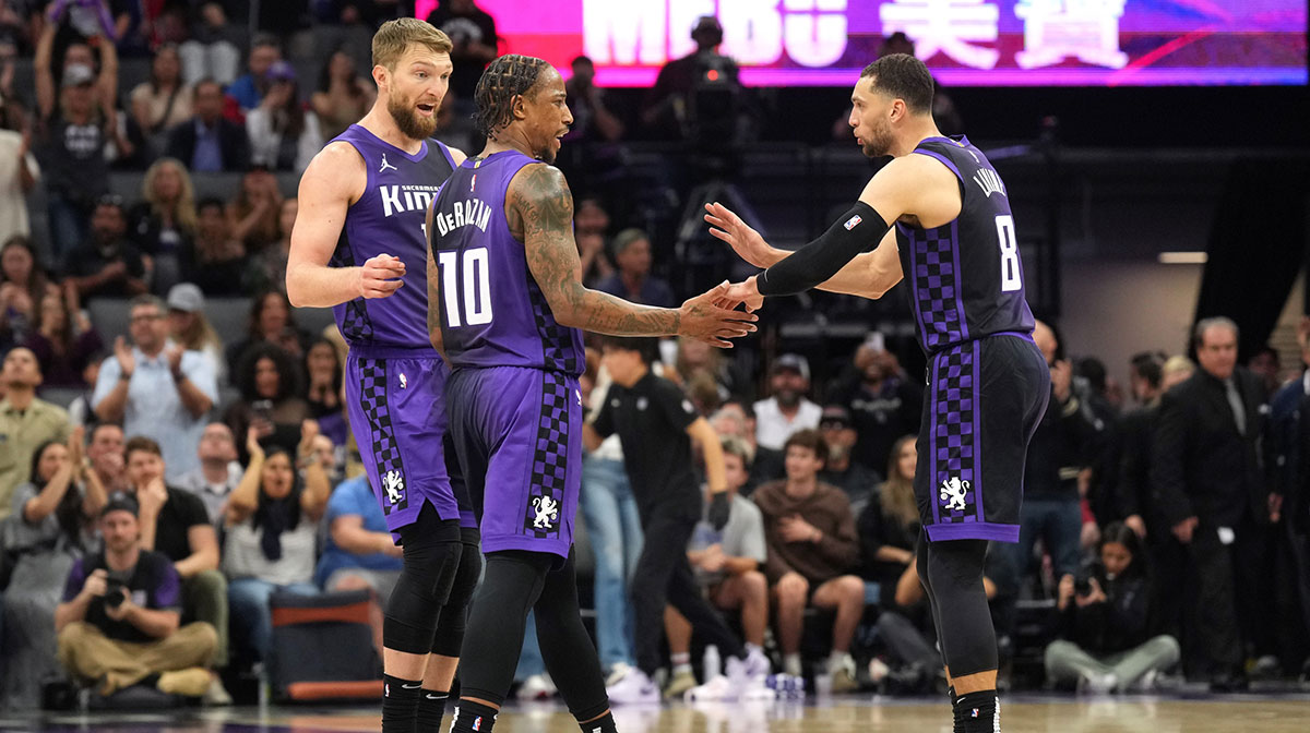 Sacramento Kings forward DeMar DeRozan (10) talks with forward Domantas Sabonis (left) and guard Zach LaVine (8) during the fourth quarter against the Los Angeles Clippers at Golden 1 Center.