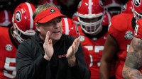 Georgia coach Kirby Smart takes the field with his team before the start of the SEC championship game against Texas