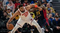 Knicks center Karl-Anthony Towns (32) controls the basketball against Golden State Warriors forward Draymond Green (23) during the third quarter at Chase Center next for the Knicks are the Pistons