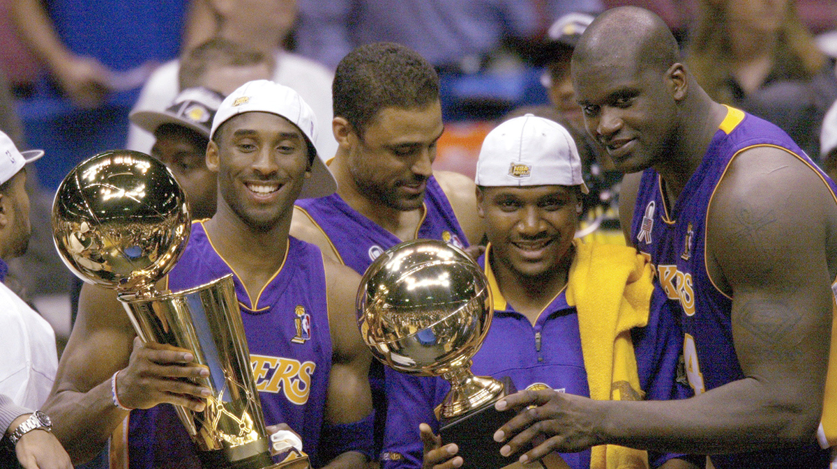 (left to right) Los Angeles Lakers Kobe Bryant, Lindsay Hunter and Shaquille O'Neal hold championship trophies after winning Game 4 of the NBA Finals at The Meadowlands.
