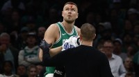 Boston Celtics star Kristaps Porzingis, who had a WWE moment after shedding blood on the court, being helped off the court against the Magic.