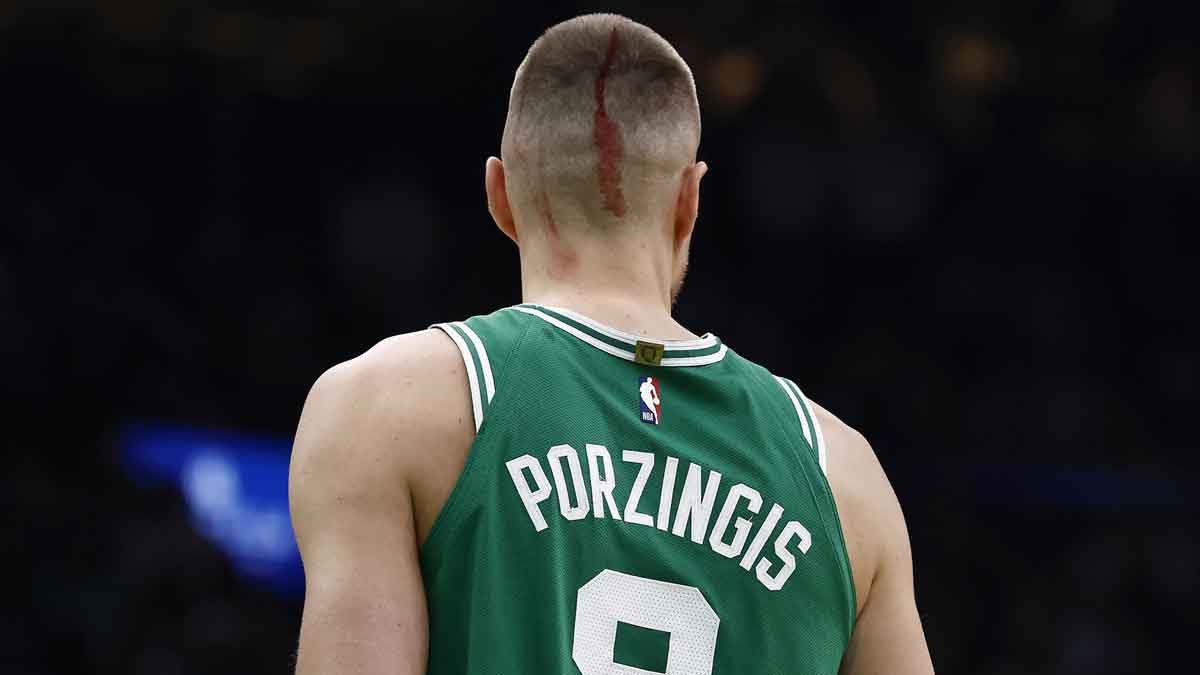 Boston Celtics center Kristaps Porzingis (8) returned to the court to shoot fouls shots after being cut by an elbow during the second half of game two of the first round of the 2024 NBA Playoffs against the Orlando Magic at TD Garden.