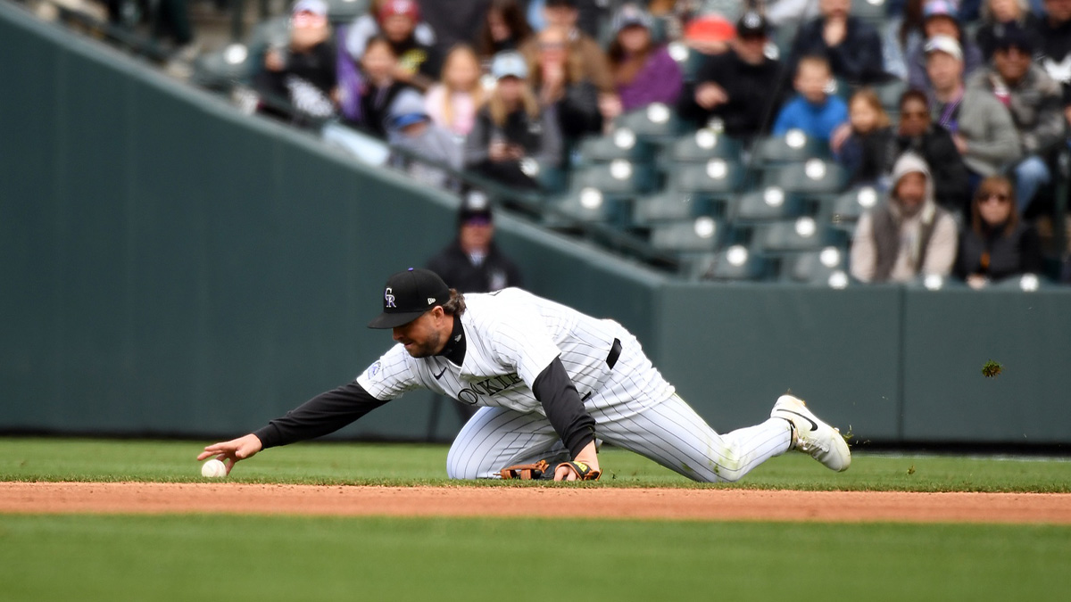 Colorado Rockies second base Kyle Farmer (6) is unable to field a ball on a play during the fourth inning against the Washington Nationals at Coors Field