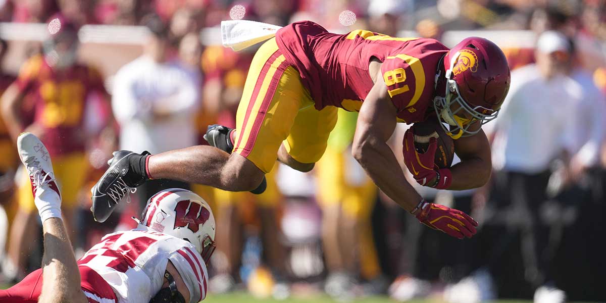 Southern California Trojans wide receiver Kyle Ford (81) carries the ball ball against Wisconsin Badgers safety Hunter Wohler (24) in the second half at United Airlines Field at Los Angeles Memorial Coliseum. Mandatory Credit: Kirby Lee-Imagn Images