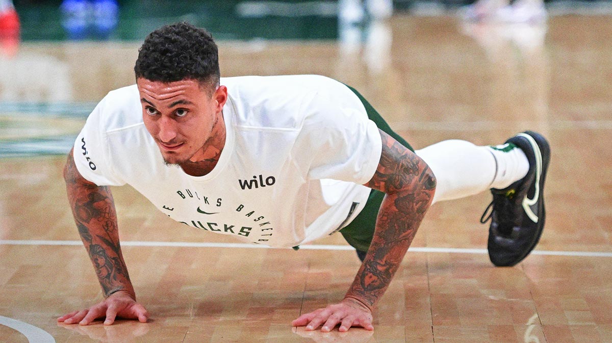 Milwaukee Bucks forward Kyle Kuzma (18) does pushups before game against the New Orleans Pelicans at Fiserv Forum.