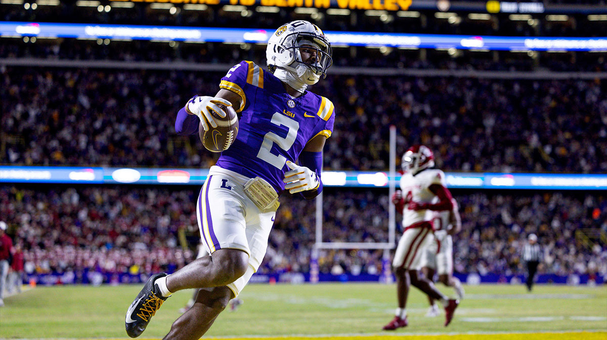 LSU Tigers wide receiver Kyren Lacy (2) runs after a catch and scores a touchdown against Oklahoma Sooners defensive back Billy Bowman Jr. (2) during the first quarter at Tiger Stadium.
