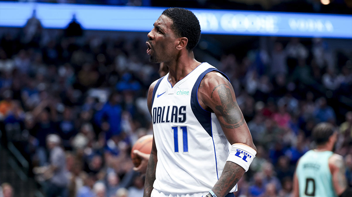 Dallas Mavericks guard Kyrie Irving (11) reacts after scoring against the Charlotte Hornets during the second half at American Airlines Center.