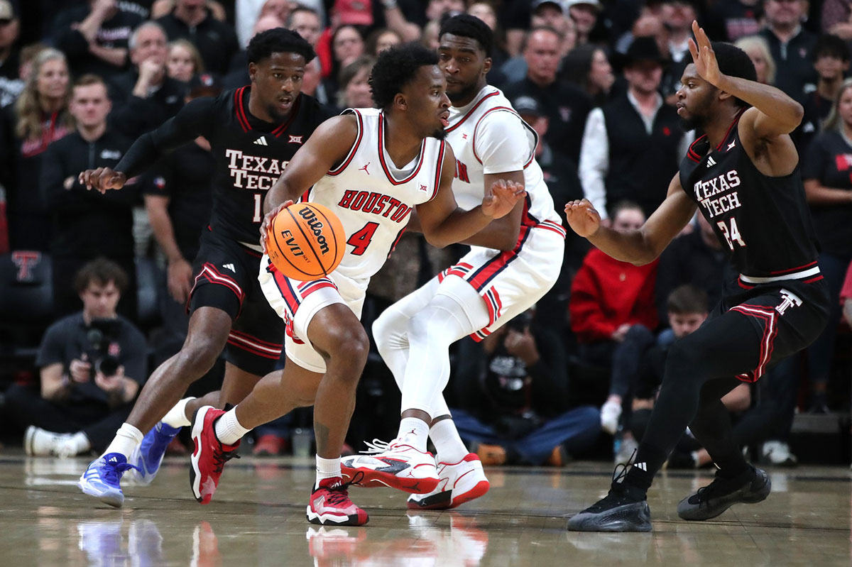Houston Cougars guard LJ Cryer (4) dribbles the ball against Texas Tech Red Raiders guard Kerwin Walton (24) in the first half at United Supermarkets Arena.