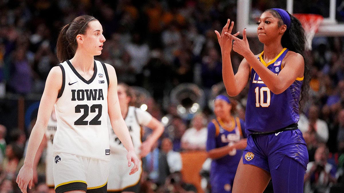 LSU forward Angel Reese (10) shows Iowa guard Caitlin Clark (22) her ring finger during final seconds of the NCAA Women's National Championship basketball game in Dallas, Sunday, April 2, 2023.