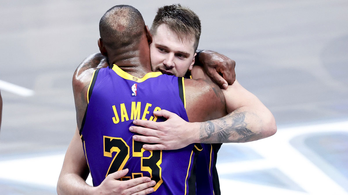 Los Angeles Lakers guard Luka Doncic (77) celebrates with Los Angeles Lakers forward LeBron James (23) during the fourth quarter against the Dallas Mavericks at American Airlines Center.