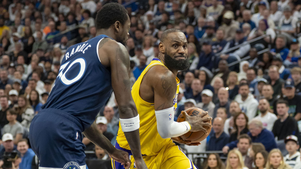 Los Angeles Lakers forward LeBron James (23) drives to the basket past Minnesota Timberwolves forward Julius Randle (30) in the first half during game three of first round for the 2024 NBA Playoffs at Target Center.